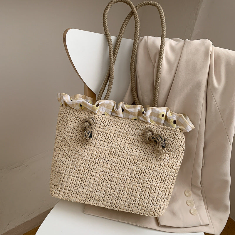 Fashion women's summer straw tote bag, woven raffia design, medium size, khaki color, with drawstring opening and double strap handles.