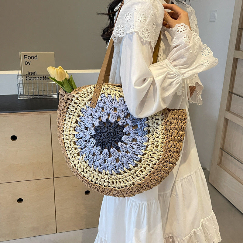 Round crochet straw bag with colorful design, single shoulder strap, and urban simplicity style, suitable for daily use.
