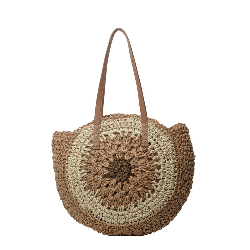 Color crochet round one shoulder straw bag with woven design and medium softness.