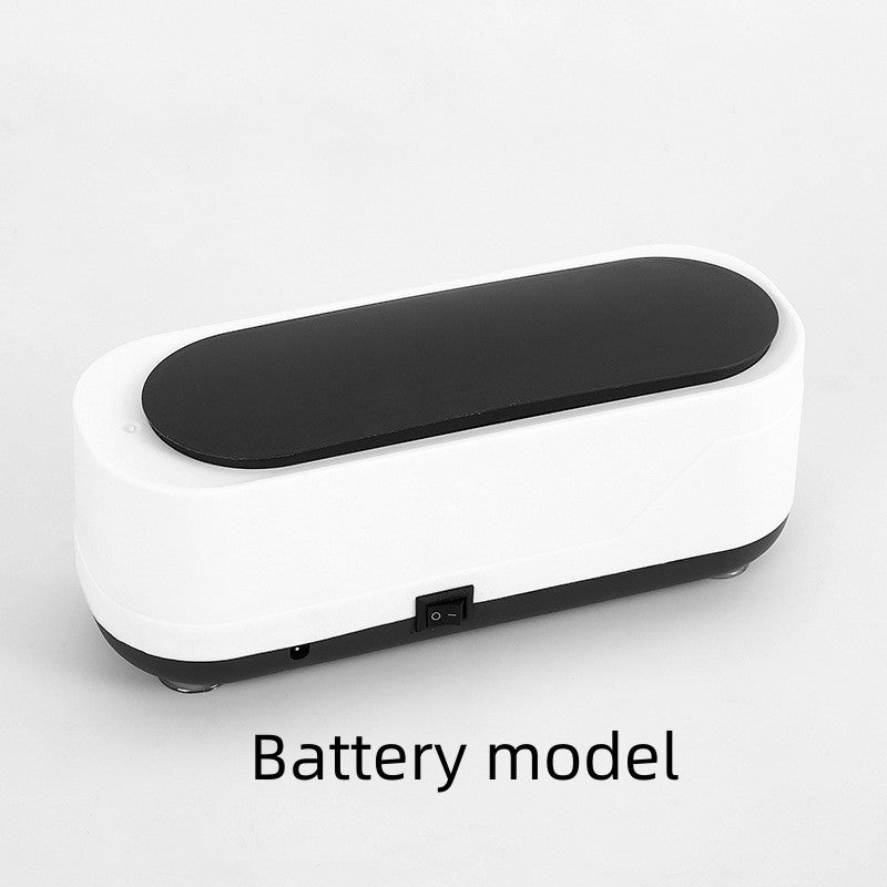 Ultrasonic eyeglasses cleaner in black and white, battery model.